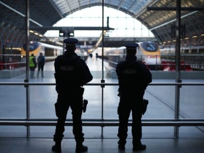LONDON, ENGLAND - JANUARY 08: Armed British Transport Police officers patrol the Eurostar platforms at St Pancras railway station on January 8, 2015 in London, United Kingdom. France is on maximum security threat level after twelve people were killed, including two police officers, at the offices of the satirical magazine …