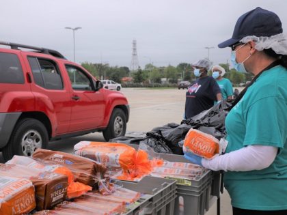 Houston volunteers load more than 4,000 cars with food during the coronavirus pandemic. (P
