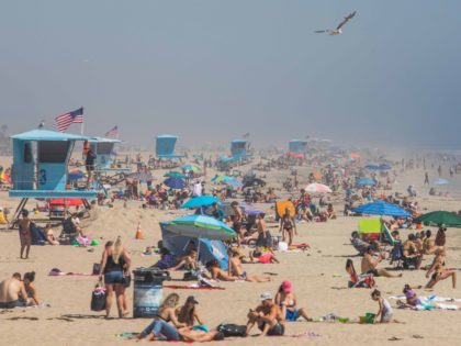 People enjoy the beach amid the novel coronavirus pandemic in Huntington Beach, California