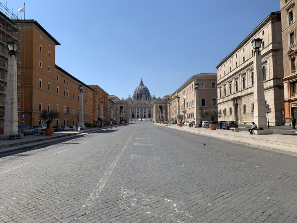 Via della Conciliazione leading up to Saint Peter's Square, with one lone homeless man.