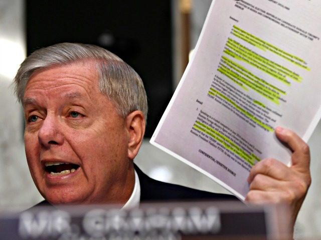Senate Judiciary Committee Chairman Lindsey Graham, R-S.C., holds up a copy of the "Steele Dossier" during a hearing with Department of Justice Inspector General Michael Horowitz on Capitol Hill in Washington, Wednesday, Dec. 11, 2019, to look at the Inspector General's report on alleged abuses of the Foreign Intelligence Surveillance …