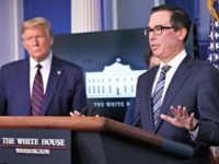 President Donald Trump listens as Treasury Secretary Steven Mnuchin speaks about the coronavirus in the James Brady Press Briefing Room of the White House, Thursday, April 2, 2020, in Washington. (AP Photo/Alex Brandon)