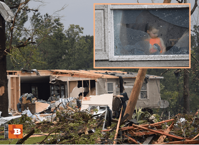 A young boy stares out the window of one of the only rooms left in his home after a deadly tornado tore it apart. (Photo: Lana Shadwick/Breitbart Texas)
