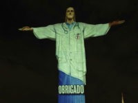 Rio's Christ the Redeemer statue is lit up in the likeness of a doctor and with the word "Thanks" projected in Portuguese, during an Easter service, in the midst of the new coronavirus pandemic, Rio de Janeiro, Brazil, Sunday, April 12, 2020. (AP Photo/Silvia Izquierdo)