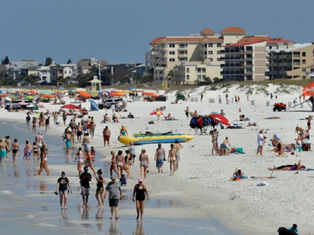Visitors enjoy Clearwater Beach, Wednesday, March 18, 2020, in Clearwater Beach, Fla. Beac