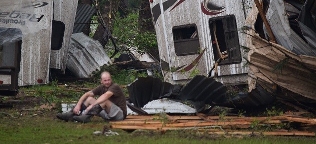 An Onalaska man sits outside his overturned fifth-wheeler in the wake of the deadly tornado that struck Polk County on April 22. (Photo: Lana Shadwick Breitbart Texas)
