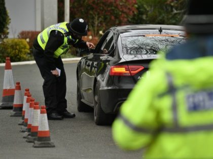 Police officers from North Yorkshire Police stop motorists in cars to check that their tra