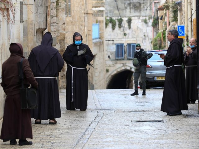 Fransiscan friars, some wearing protective gear amid the COVID-19 outbreak, pray at the first station while taking part in a small Procession of the Way of the Cross along the Via Dolorosa to mark Good Friday in Jerusalem, on April 10, 2020. - All cultural sites in the Holy Land …