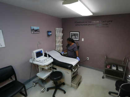 Director of Clinical Services, Marva Sadler, prepares the operating room at the Whole Woma