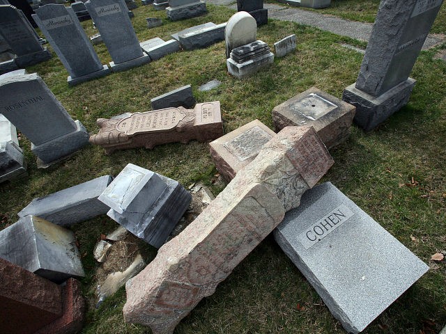 FILE - In this Feb. 27, 2017 file photo, headstones toppled and damaged by vandals lie on