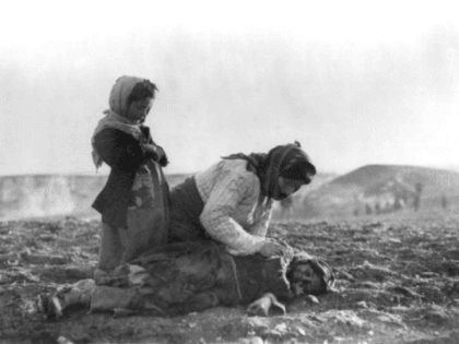 An Armenian woman kneeling beside a dead child in a field “within sight of help and safety at Aleppo”. Source: Wikipedia