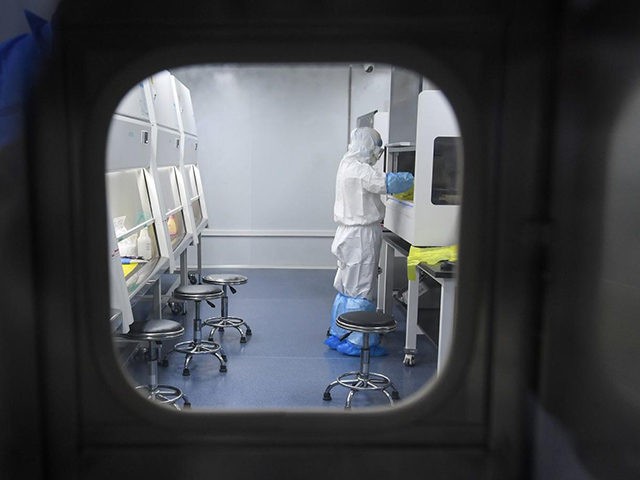 This photo taken on February 6, 2020 shows a laboratory technician working on samples from