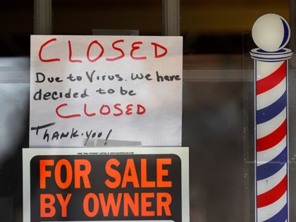 "For Sale By Owner" and "Closed Due to Virus" signs are displayed in the window of Images On Mack in Grosse Pointe Woods, Mich., Thursday, April 2, 2020. The coronavirus outbreak has triggered a stunning collapse in the U.S. workforce with 10 million people losing their jobs in the past …