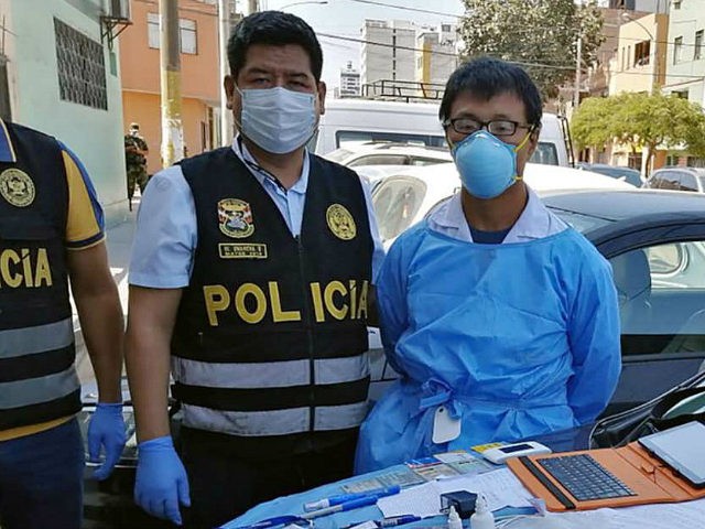 A Peruvian police photo showing Chinese citizen Zhang Tianxing (right) after his arrest fo