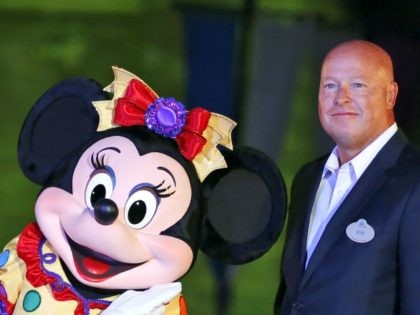 Disney-New-CEO FILE - In this Sept. 11, 2015, file photo, Chairman of Walt Disney Parks and Resorts Bob Chapek poses with Minnie Mouse during a ceremony at the Hong Kong Disneyland, as they celebrate the Hong Kong Disneyland's 10th anniversary. The Walt Disney Co. has named Bob Chapek CEO, replacing …