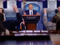 President Donald Trump responds to questions during a coronavirus task force briefing at the White House, Sunday, April 5, 2020, in Washington. Dr. Deborah Birx, White House coronavirus response coordinator, left, and Navy Rear Adm. John Polowczyk, supply chain task force lead at FEMA, right, listen. (AP Photo/Patrick Semansky)