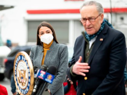 Senate Minority Leader Chuck Schumer speaks as Democratic Congresswoman from New York Alexandria Ocasio-Cortez wearing a face mask to protect herself from the coronavirus, listens during a press conference in the Corona neighbourhood of Queens on April 14, 2020 in New York City. - Senate Minority Leader Chuck Schumer and …