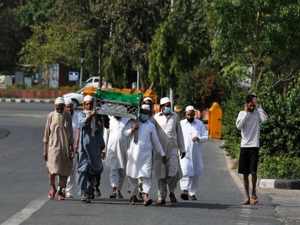 A group of Indian Muslims carry their relative who died due to natural reasons for burial during 21 day nationwide lockdown to control the spread of the new coronavirus New Delhi, India, Monday, April 13, 2020. The new coronavirus causes mild or moderate symptoms for most people, but for some, …