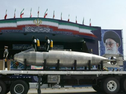 Tehran, IRAN: An Iranian made light submarine is displayed during the army day military parade, outside the mausoleum of the late founder of Islamic republic, Ayatollah Khomeini (poster) in Tehran, 18 April 2007. Iranian President Mahmoud Ahmadinejad vowed today that Iran's armed forces would "cut off the hand" of any …