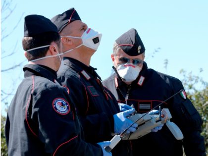 A Carabinieri (Italian paramilitary police) officers maneuvers a drone to check people's m