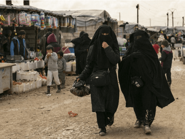 In this March 31, 2019 photo, women shop in a marketplace at Al-Hol camp, home to families of Islamic State fighters, in Hasakeh province, Syria. (AP Photo/Maya Alleruzzo)