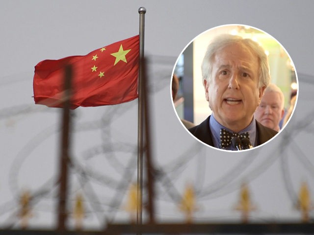 (INSET: Bloomberg News Editor-in-Chief Emeritus and co-founder Matthew Winkler) TOPSHOT - This photo taken on June 4, 2019 shows the Chinese flag behind razor wire at a housing compound in Yangisar, south of Kashgar, in China's western Xinjiang region. - A recurrence of the Urumqi riots which left nearly 200 …