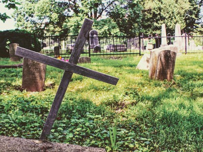 photography-of-wooden-cross-on-green-grass-1148541