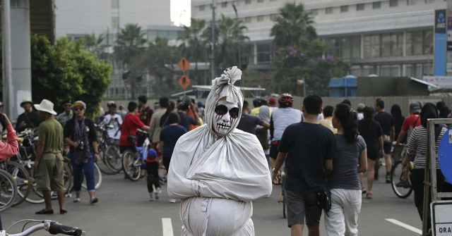 Indonesians Dress Up As 'Ghosts' To Scare People Into Social Distancing