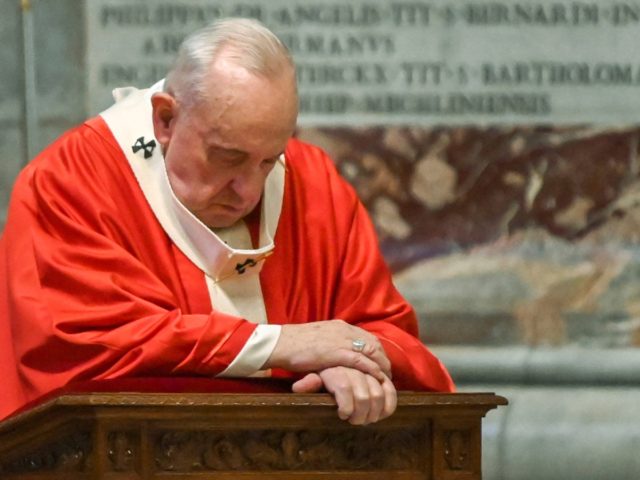 Pope Francis prays as he celebrates Palm Sunday Mass behind closed doors in St. Peter's Ba