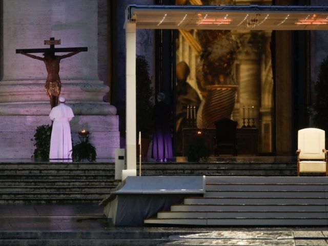 Pope Francis, left, prays in front of a miraculous crucifix that in 1552 was carried in a procession around Rome to stop the great plague, during Urbi and Orbi prayer (Latin for To the City and To the World) from an empty St. Peter's Square, at the Vatican, Friday, March …