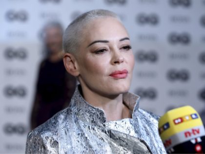 Actress Rose McGowan talks to press on arrival at the 'GQ Men of The Year' Award