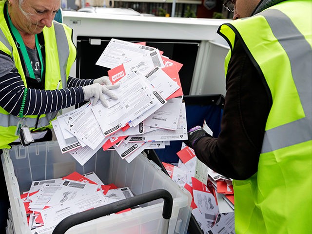 King County Election workers collect ballots from a drop box in the Washington State prima