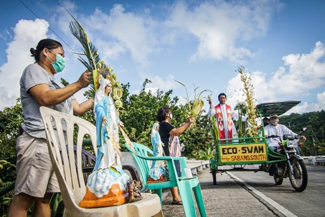 Roman Catholic priest Pepe Quitorio delivers blessing from a motorised tricycle in Borongan in the central Philippines © AFP Alren BERONIO
