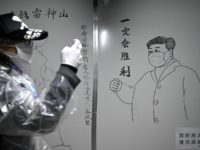 A man walks in front of a drawing of Chinese President Xi Jinping on a wall at the Leishenshan Hospital that had offered beds for coronavirus patients in Wuhan, in Chinas central Hubei province on April 11, 2020. (Photo by Noel Celis / AFP) (Photo by NOEL CELIS/AFP via Getty …