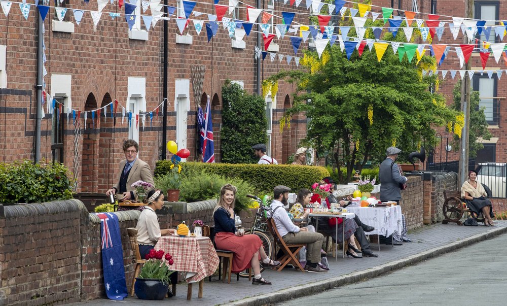 The residents of Cambrian Road in Chester dress up in 1945 clothing and have a social distancing tea party to mark the 75th anniversary of VE Day, Friday May 8, 2020. Although large-scale public events are unable to go ahead because of coronavirus restrictions, tributes will be paid by politicians and members of the royal family, as well as through a host of other events as the nation remembers those who fought and died in World War II. (Peter Byrne/PA via AP)