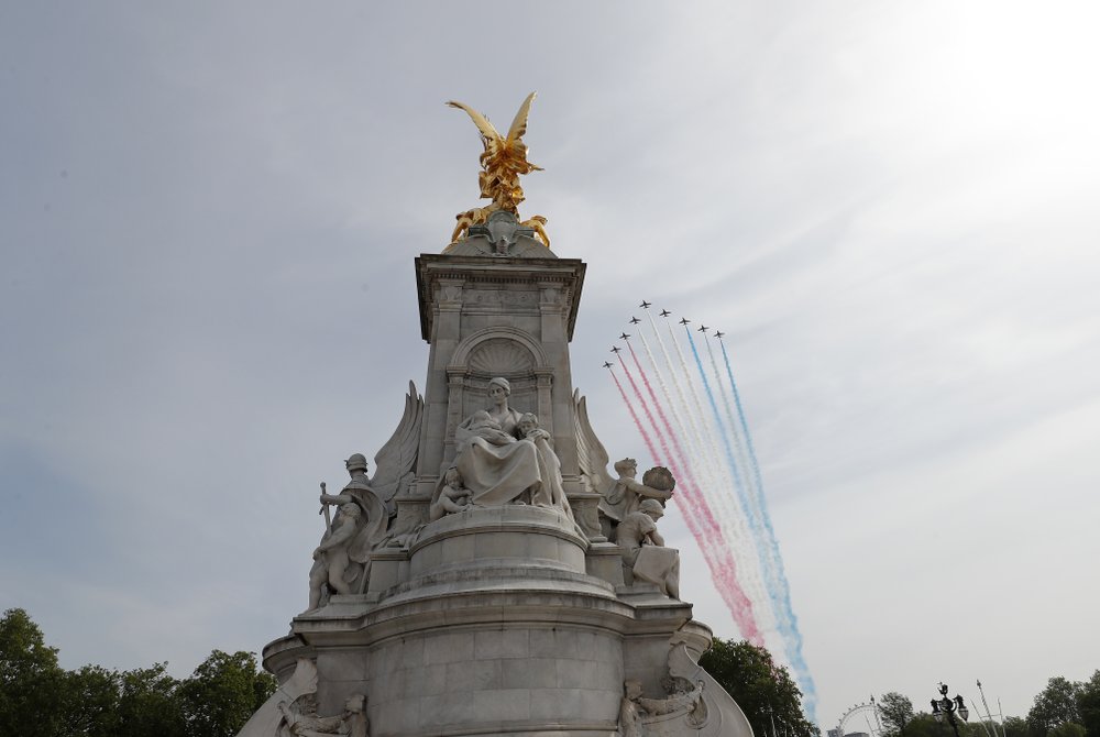 The Red Arrows, officially known as the Royal Air Force Aerobatic Team flies over the Queen Victoria Memorial outside Buckingham Palace in London, Friday, May 8, 2020 on the 75th anniversary of the end of World War II in Europe. The 75th anniversary of the end of World War II in Europe should be all about parades, remembrances, and one last great hurrah for veteran soldiers who are mostly in their nineties. Instead, it is a time of coronavirus lockdown and loneliness spent in search of memories both bitter and sweet. (AP Photo/Frank Augstein)