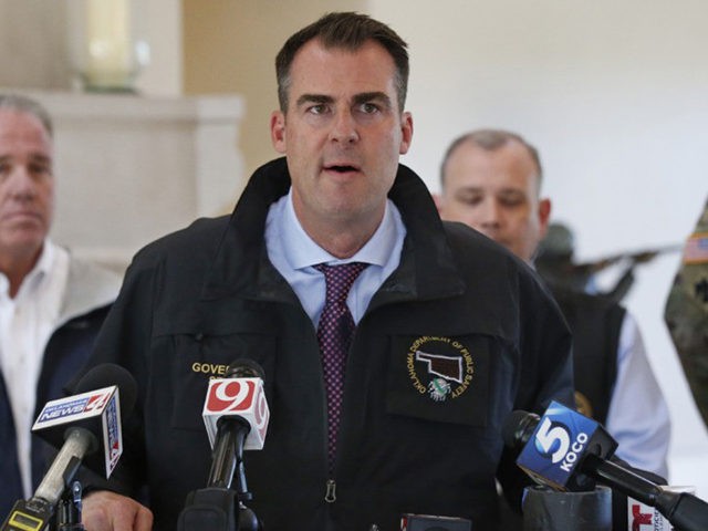 Oklahoma Gov. Kevin Stitt talks with the media following an aerial tour of tornado and flood damaged areas of the state, Tuesday, May 21, 2019, in Oklahoma City. (AP Photo/Sue Ogrocki)