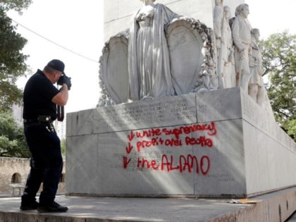 San Antonio Police Department Senior Crime Scene Investigator Robert Rackley collects evidence at the site where the Alamo Cenotaph was vandalised with spray paint in San Antonio, Friday, May 29, 2020. (AP Photo/Eric Gay)
