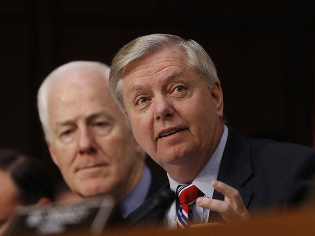 Senate Judiciary Committee member Sen. Lindsey Graham, R-S.C., right, accompanied by Sen. John Cornyn, R-Texas, speaks on Capitol Hill in Washington, Monday, March 20, 2017, during the committee's confirmation hearing for Supreme Court Justice nominee Neil Gorsuch. (AP Photo/Pablo Martinez Monsivais)