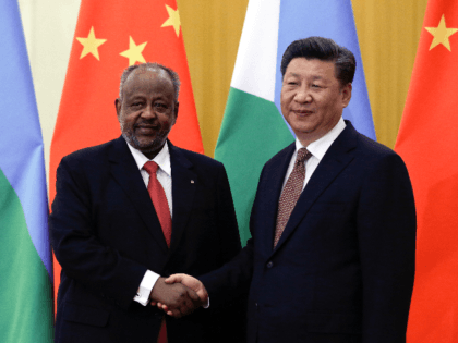Djibouti's President Ismail Omar Guelleh, left, poses with Chinese President Xi Jinping for a photo before their bilateral meeting at the Great Hall of the People in Beijing, Sunday, Sept. 2, 2018. (AP Photo/Andy Wong, Pool)