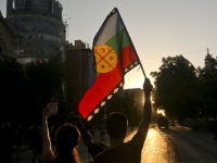 Protesters fly a Mapuche flag during clashes triggered by the death of Mapuche indigenous man Camilo Catrillanca, in front of the Universidad de Chile, in Santiago, Chile, Wednesday, Nov. 21, 2018. The death of Catrillanca, shot in the head when the police was chasing unidentified car thieves, unleashed protests and …
