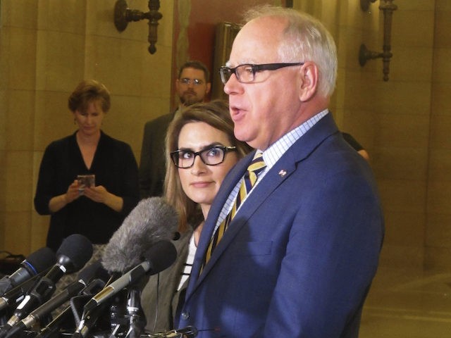 Democratic Minnesota Gov. Tim Walz, right, accompanied by Lt. Gov. Peggy Flanagan, left, speaks with reporters during a break in budget talks at the state Capitol in St. Paul, Minnesota, on Tuesday, May 14, 2019. (AP Photo/Steve Karnowski)