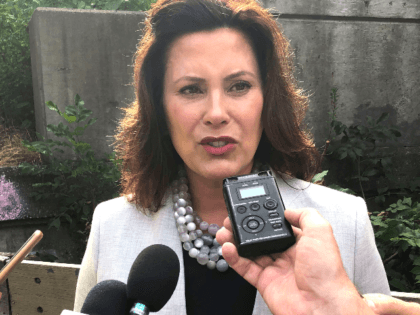Gov. Gretchen Whitmer speaks with reporters after inspecting the Elm Street bridge over the Red Cedar River, Monday, Aug. 12, 2019, in Lansing, Mich. Whitmer says it is important that the public knows the seriousness of the state's "infrastructure crisis." (AP Photo/David Eggert)