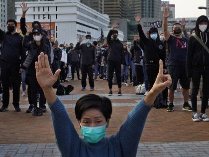 Protesters raise five demands gestures during a rally in Hong Kong, Sunday, Jan. 12, 2020.