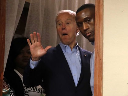 Democratic presidential candidate former Vice President Joe Biden waves to a supporter as he waits off-stage to be introduced at an NAACP block party at Urban Dreams in Des Moines, Iowa, Sunday, Jan. 26, 2020. (AP Photo/Gene J. Puskar)