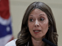 Ohio Department of Health Director Amy Acton holds up a mask as she gives an update at MetroHealth Medical Center Thursday, Feb. 27, 2020, in Cleveland, on the state's preparedness and education efforts to limit the potential spread of a new virus which caused a disease called COVID-19. (AP Photo/Tony …