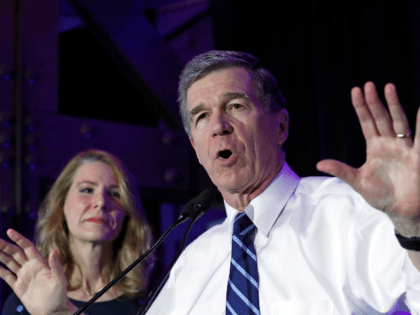 North Carolina Gov. Roy Cooper speaks to supporters while joined by his wife Kristin durin