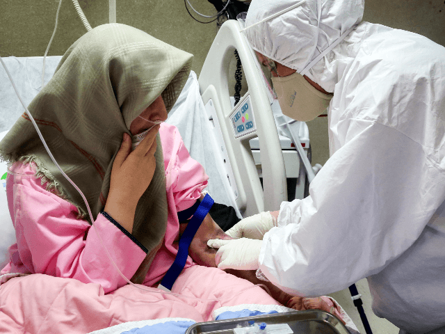 In this Saturday, March 7, 2020, a medic wearing protective gear treats a patient infected with the new coronavirus, at Baqiyatallah Al'Azam Hospital affiliated to the Revolutionary Guard, in Tehran, Iran. Iran is the hardest-hit country in the Mideast by the new coronavirus, which sickens but largely doesn't kill those …