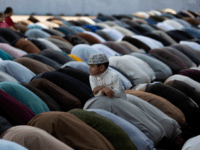 A Pakistani boy stands amid of people offer Friday prayers besides government's advice to avoid public gathering to avoid contracting coronavirus, at a local mosque in Rawalpindi, Pakistan, Pakistan, March 20, 2020. The vast majority of people recover from the new coronavirus. According to the World Health Organization, most people …
