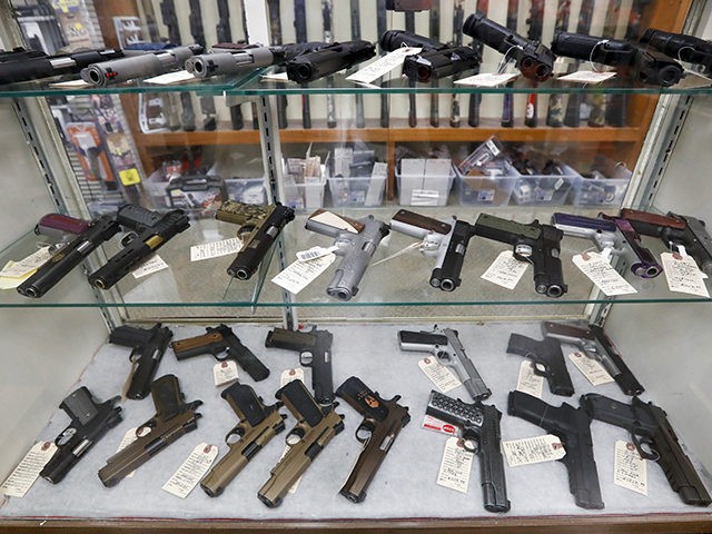 Semi-Automatic handguns are displayed at Duke's Sport Shop, Wednesday, March 25, 2020, in New Castle, Pa. (AP Photo/Keith Srakocic)